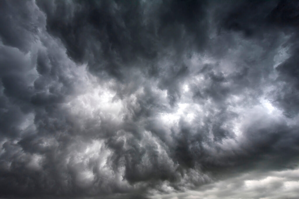 Dramatic dark storm rain clouds black sky background. Dark thunderstorm clouds rainny atmosphere. Meteorology danger windstorm disasters climate. Dark cloudscape storm disaster gloomy gray cloud sky